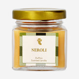 Flying Tiger Copenhagen scented candle with Neroli fragrance, showcasing a lit candle in a glass holder for home ambiance.