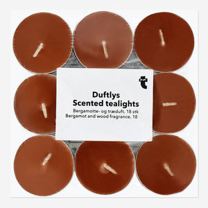Set of 18 scented tealights with bergamot and wood fragrance from Flying Tiger Copenhagen, perfect for home ambiance.
