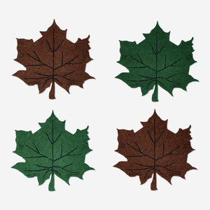 Set of four leaf-shaped felt coasters in natural colors, designed for kitchen use by Flying Tiger Copenhagen.
