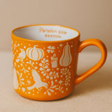 Orange ceramic mug with pumpkin print, 480 ml capacity, by Flying Tiger Copenhagen, perfect for autumn-themed kitchenware.