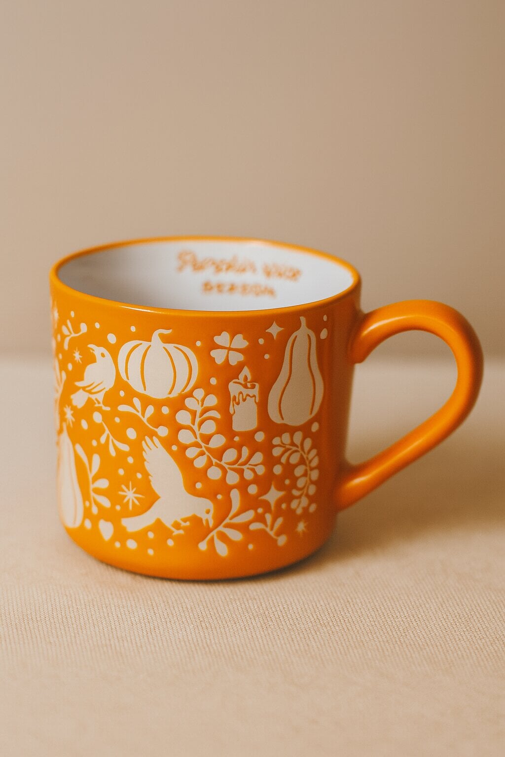Orange ceramic mug with pumpkin print, 480 ml capacity, by Flying Tiger Copenhagen, perfect for autumn-themed kitchenware.