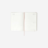 A5 Linen daily diary 2026 by Flying Tiger Copenhagen, open to show pages, with a soft linen cover in natural color.