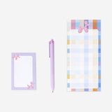 Checkered notepad with pen and memos
