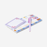 Checkered notepad with pen and memos