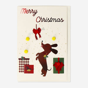 Christmas greetings card featuring a cute sausage dog design, from Flying Tiger Copenhagen, suitable for office holiday celebrations.