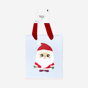 Set of four Flying Tiger Copenhagen Christmas character gift bags for office holiday gift wrapping, featuring festive designs.