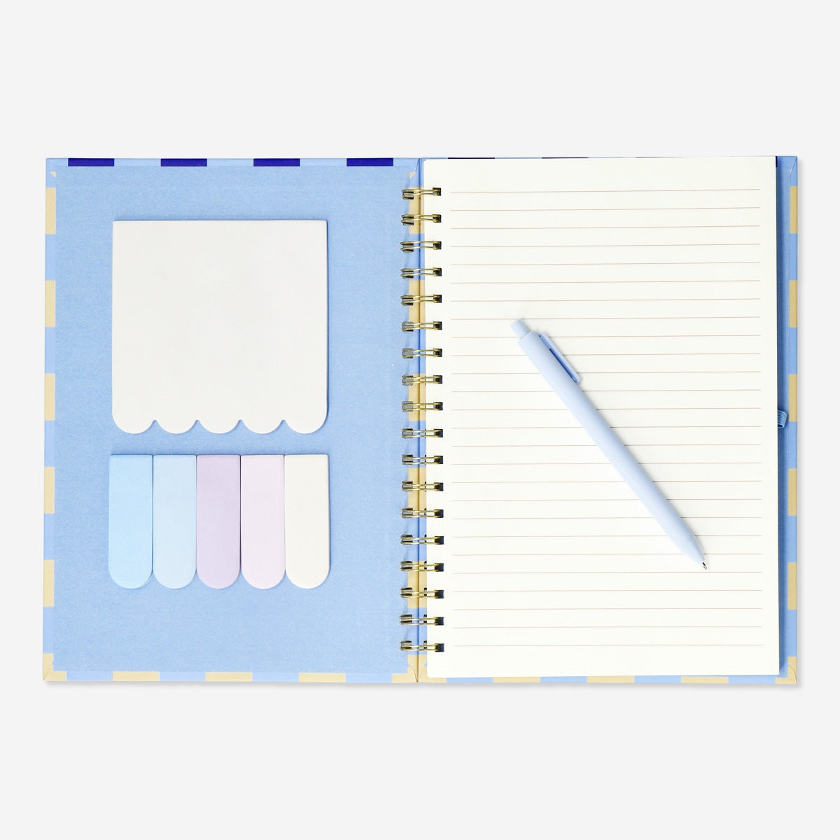 Flying Tiger Copenhagen office notebook with ballpoint pen and sticky memos on a desk for note-taking and organization.