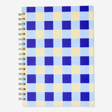 Office notebook from Flying Tiger Copenhagen with a ballpoint pen and sticky memos on a desk.
