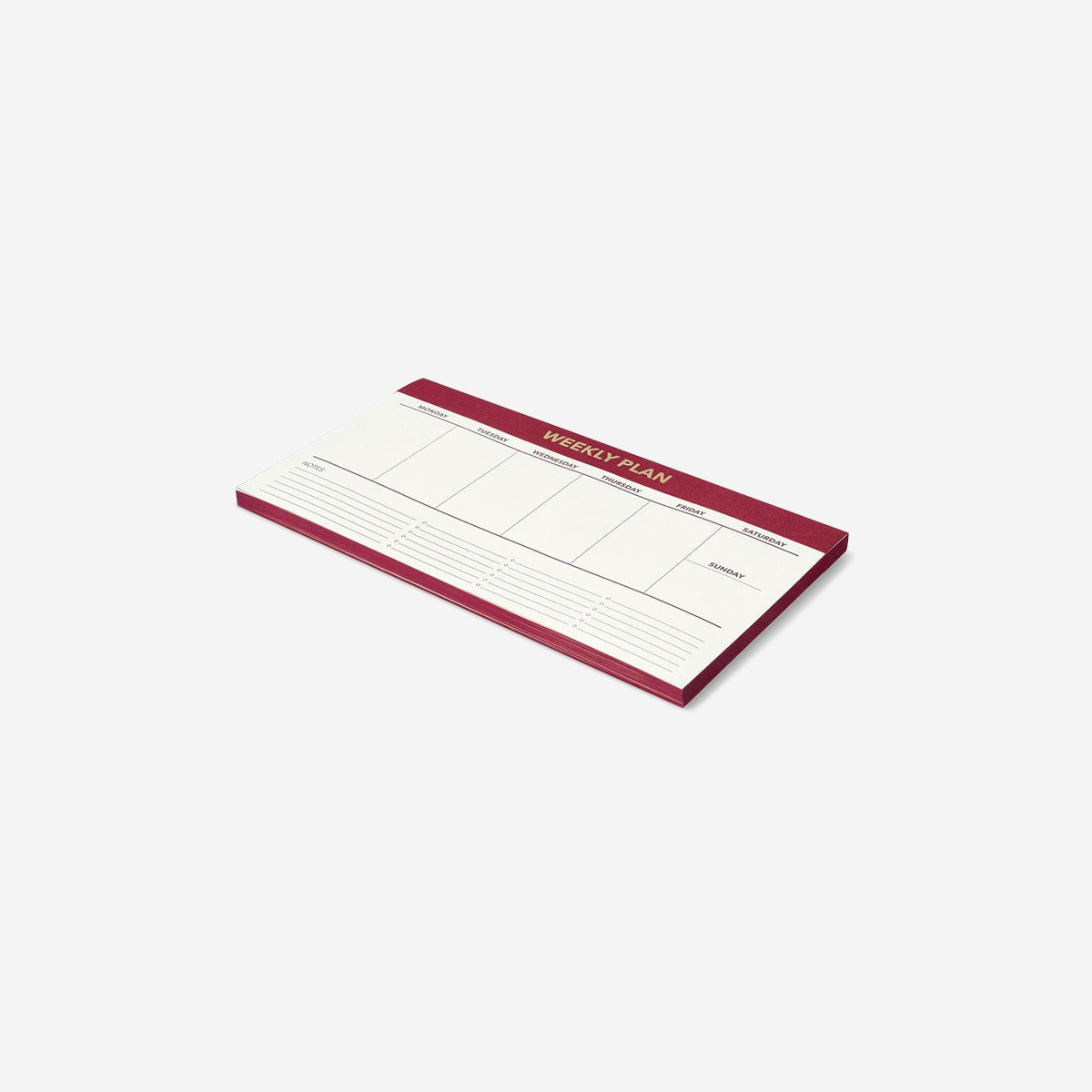 Red weekly planner for desk by Flying Tiger Copenhagen, designed for organizing weekly schedules in an office setting.