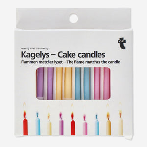 Colorful Flying Tiger Copenhagen party cake candles arranged on a white surface for celebration.