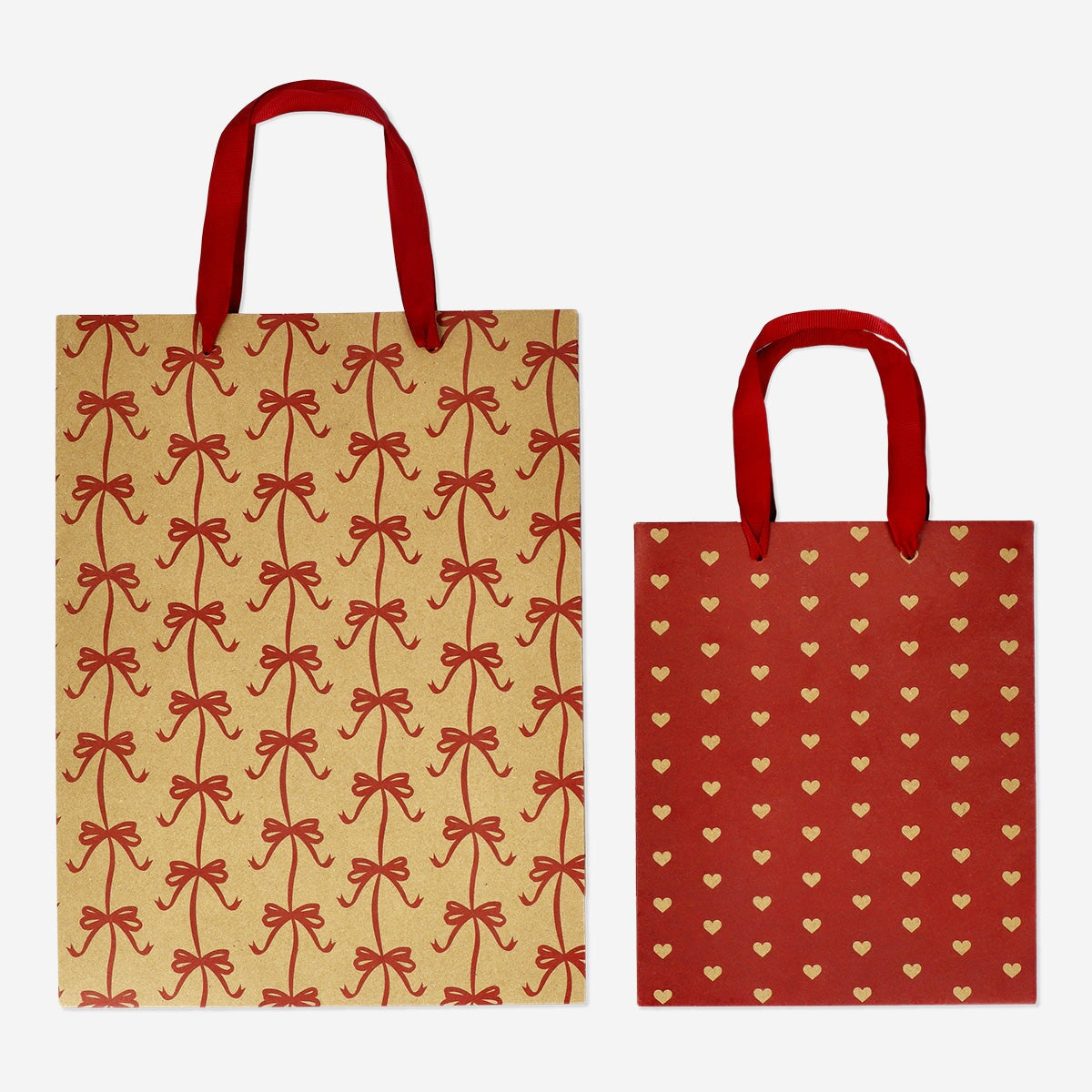 Two festive Christmas gift bags from Flying Tiger Copenhagen, designed for party gift wrapping, featuring holiday-themed patterns.