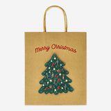 Party gift bag with Christmas tree design from Flying Tiger Copenhagen, featuring festive holiday decorations.