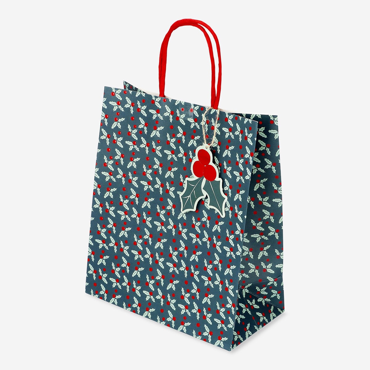 Party gift bag with debossed holly pattern from Flying Tiger Copenhagen, featuring festive holiday design and sturdy paper construction.