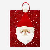 Party gift bag featuring Santa's face from Flying Tiger Copenhagen, perfect for holiday gift wrapping and festive celebrations.