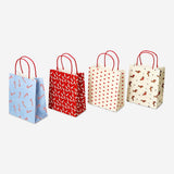 Set of four Flying Tiger Copenhagen Christmas-patterned gift bags for parties, featuring festive holiday designs.