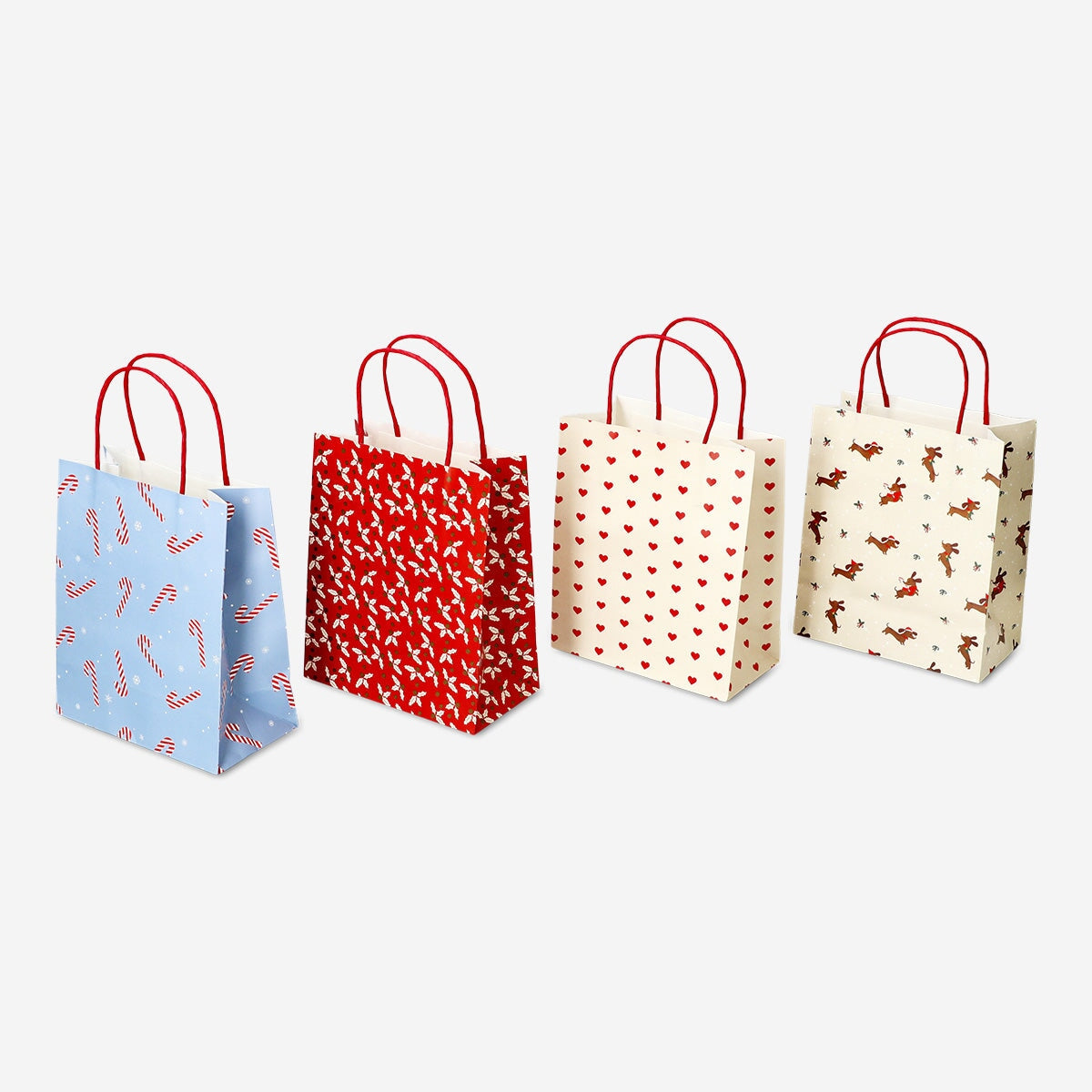 Set of four Flying Tiger Copenhagen Christmas-patterned gift bags for parties, featuring festive holiday designs.