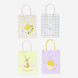 Four scalloped-edge gift bags for parties from Flying Tiger Copenhagen, featuring colorful and decorative designs.