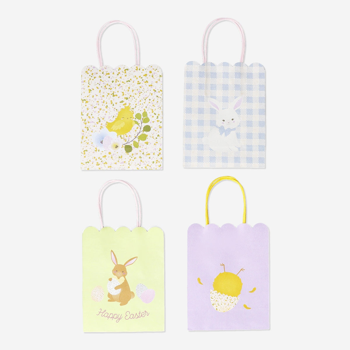 Four scalloped-edge gift bags for parties from Flying Tiger Copenhagen, featuring colorful and decorative designs.