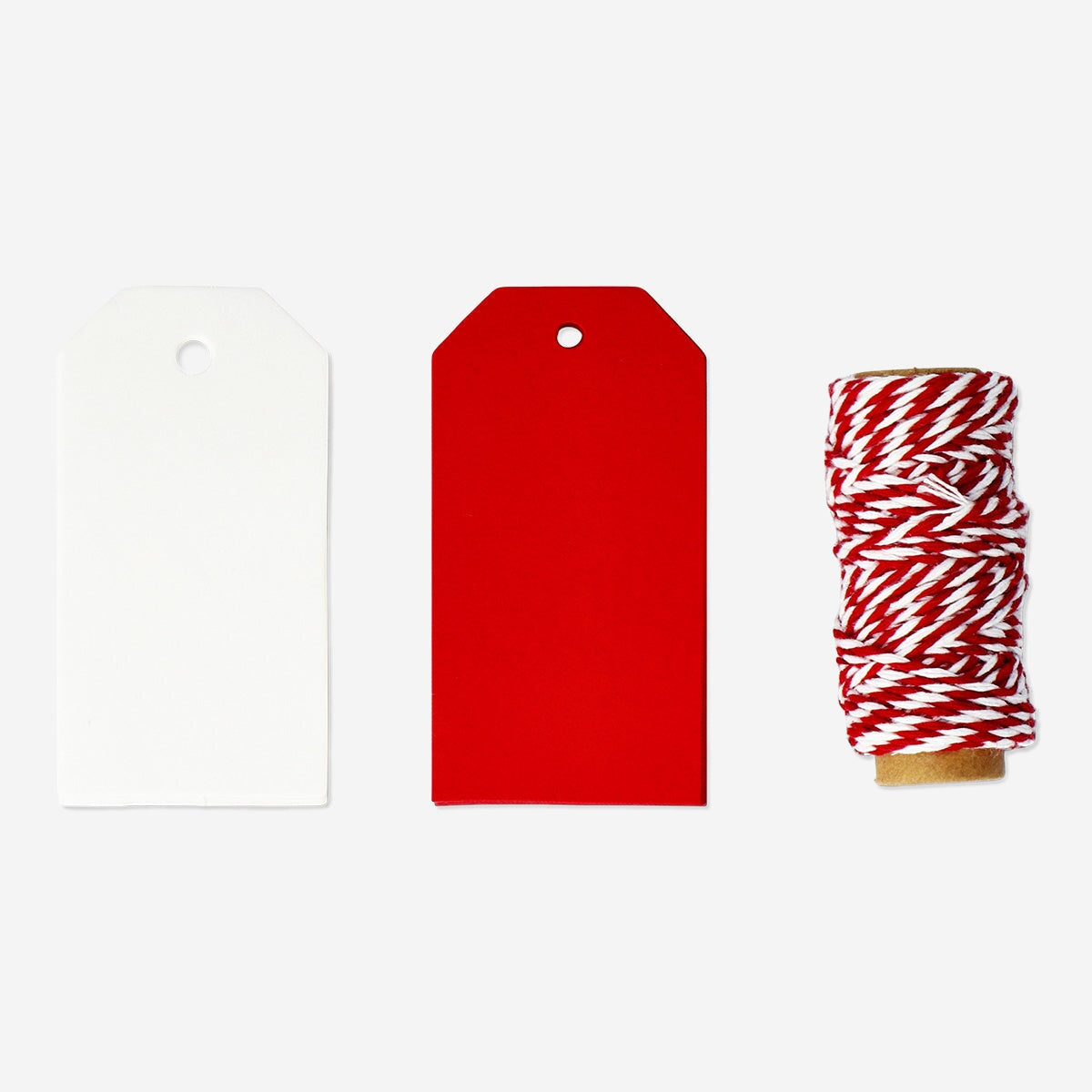 Party gift decoration set from Flying Tiger Copenhagen featuring gift tags and red ribbon for festive gift wrapping.