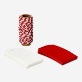 Party gift decoration set from Flying Tiger Copenhagen, includes gift tags and red ribbon for wrapping and decorating gifts.
