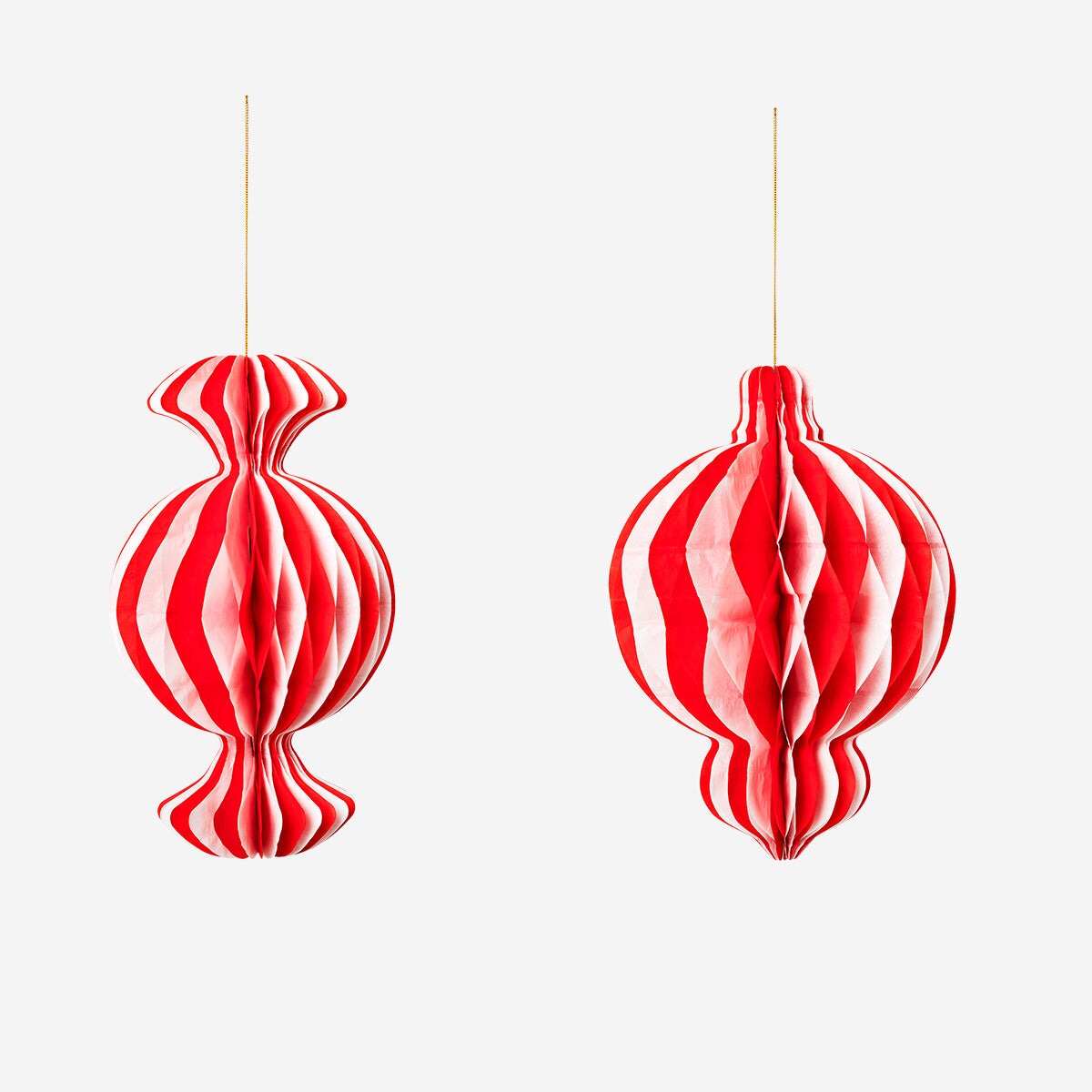 Two hanging candy-striped paper ornaments for party decoration, featuring bright red and white stripes by Flying Tiger Copenhagen.