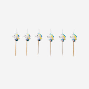 Six colorful unicorn cake candles for party decorating, from Flying Tiger Copenhagen, arranged on a white background.