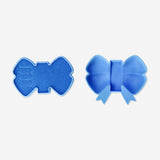 Blue bow jewelry storage box by Flying Tiger Copenhagen, designed for organizing necklaces, rings, and small accessories.
