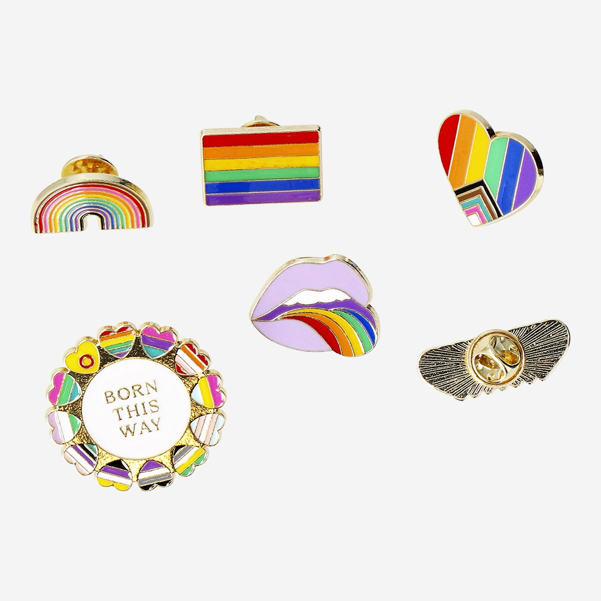 Set of six textile brooch pins with colorful rainbow motifs, featuring multi-colored metal designs from Flying Tiger Copenhagen.