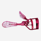 Pink glitter eyelash curler from Flying Tiger Copenhagen, designed for personal care and easy eyelash curling.
