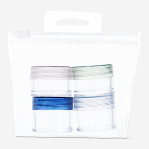 Flying Tiger Copenhagen 4-piece travel personal care set with bottles and containers for toiletries and skincare on white background.
