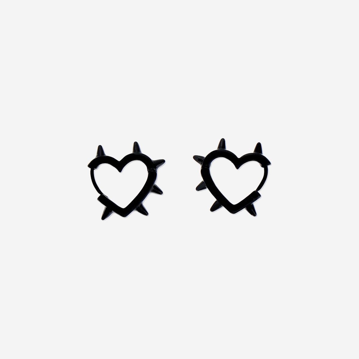 Black textile earrings with heart designs by Flying Tiger Copenhagen, featuring soft fabric and playful heart shapes.