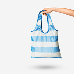 Foldable striped textile bag from Flying Tiger Copenhagen, featuring colorful horizontal stripes and compact, portable design.
