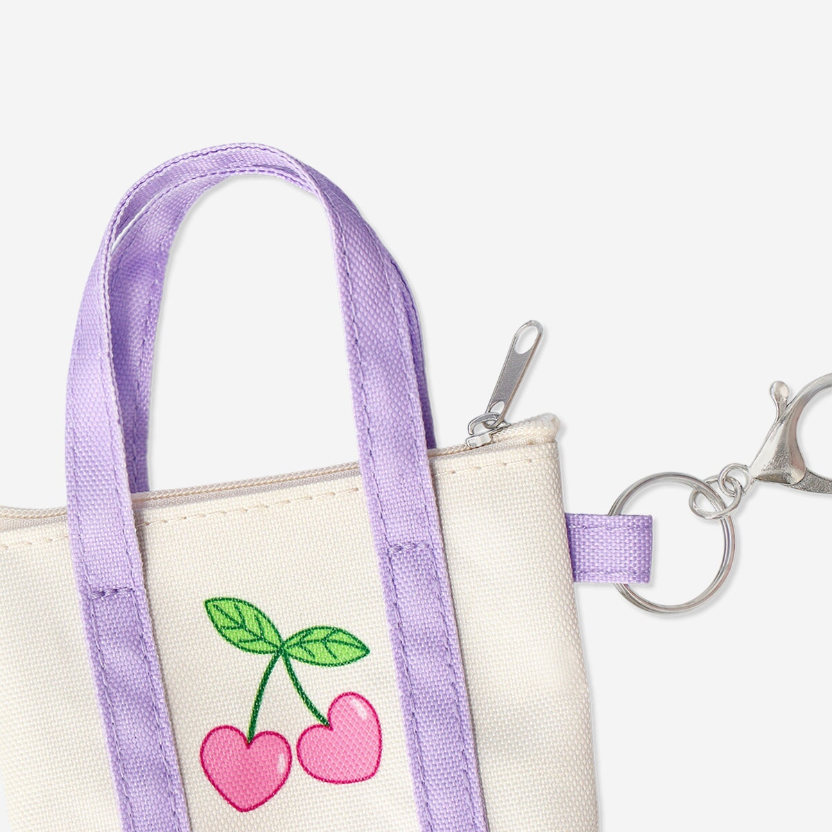 Textile key ring shaped like a mini bag from Flying Tiger Copenhagen, featuring colorful fabric design and small metal keyring attachment.