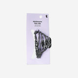 Skeleton-shaped textile hair clip from Flying Tiger Copenhagen featuring a black and white skeleton design.