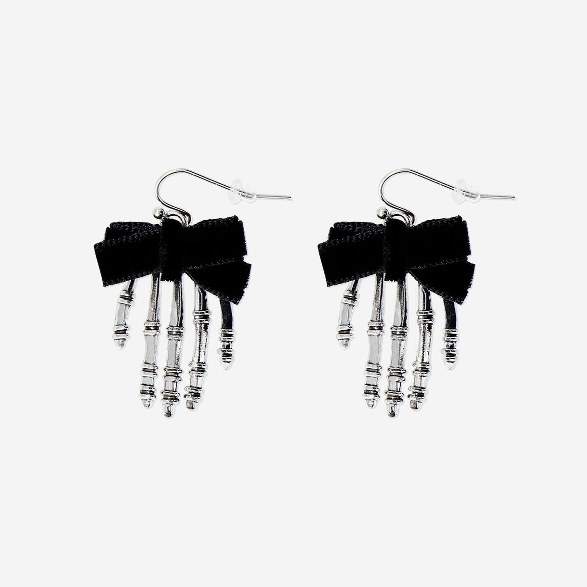 Textile skeleton hands earrings with detailed black and white design, hanging from silver hooks, by Flying Tiger Copenhagen.