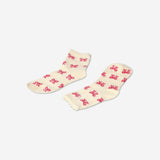 Pair of white textile socks with pink bows from Flying Tiger Copenhagen, size 36/38, displayed flat.