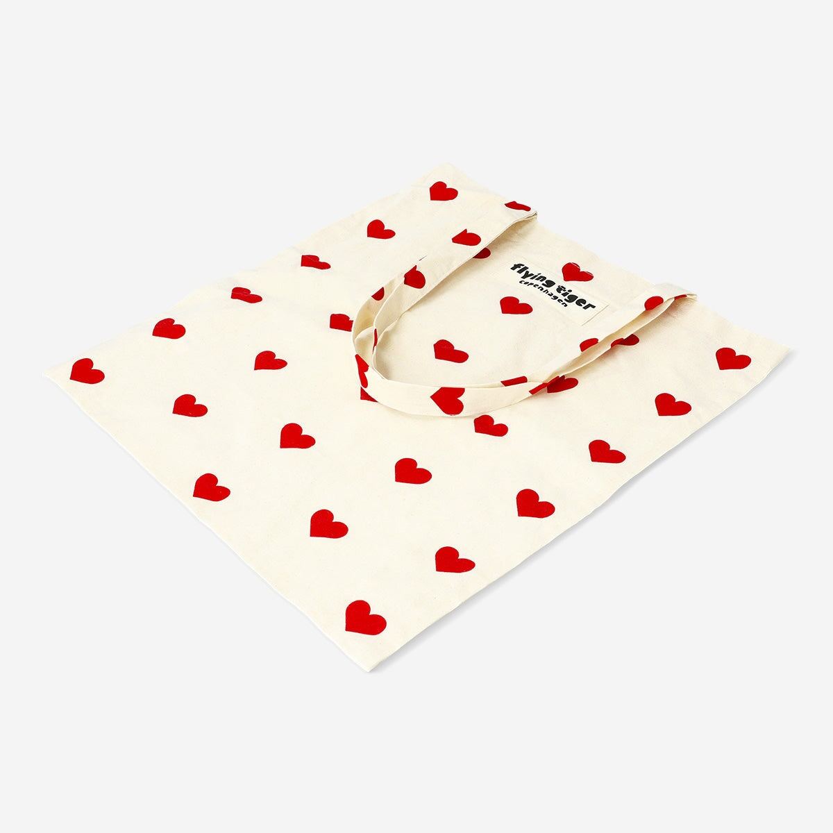 Textile tote bag with red heart designs from Flying Tiger Copenhagen, featuring a casual, fashionable tote bag look.