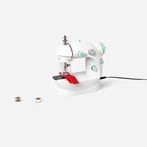 Play sewing machine toy by Flying Tiger Copenhagen with colorful buttons and fabric, designed for kids' imaginative play.