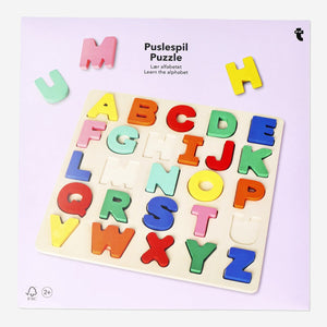 Wooden alphabet puzzle toy by Flying Tiger Copenhagen with colorful, interlocking letter pieces on a light surface.