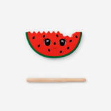 Wooden watermelon percussion toy from Flying Tiger Copenhagen, featuring a colorful, hand-crafted wooden fruit for musical play.