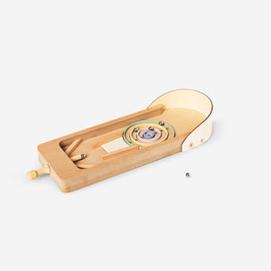 Wooden desktop pinball game by Flying Tiger Copenhagen, featuring colorful balls, ramps, and levers on a compact game surface.