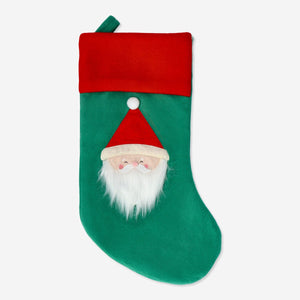 Red Flying Tiger Copenhagen Christmas stocking with festive pattern hanging on a fireplace mantel.