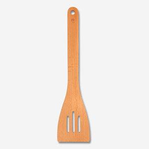 Flying Tiger Copenhagen kitchen slotted spatula with a wooden handle and stainless steel head for flipping and serving food.
