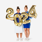 Flying Tiger Copenhagen 2024 foil balloons for party decoration, featuring shiny metallic surfaces and bold numbers.