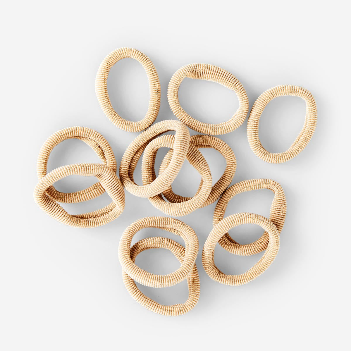 Set of 12 beige textile hair elastics from Flying Tiger Copenhagen, soft and stretchy for personal care and styling.