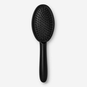 Flying Tiger Copenhagen classic hairbrush with wooden handle and bristles, designed for gentle hair detangling and styling.