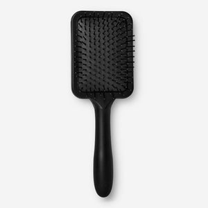 Flying Tiger Copenhagen personal care hairbrush with wooden handle and natural bristles for gentle hair detangling.