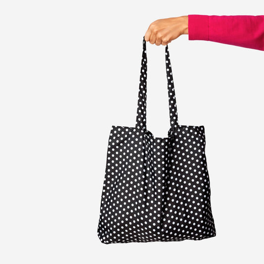 Bolso de mano plegable negro con lunares